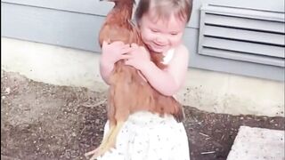 The girl is playing with the hen