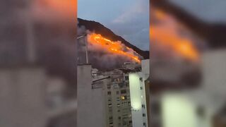 A wildfire burns the forest near Copacabana, Brazil