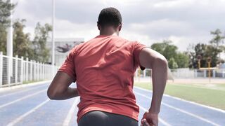 Man From Behind Running In A Sports Center