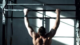 Man Training On The Bars In The gym