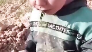 The poor kid is eating grass
