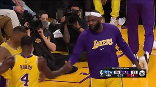 Russell Westbrook and Rajon Rondo hugging each other on the sidelines 