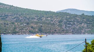 Croatia, Europe: Firefighting Plane refilling water.