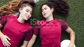 Two Happy Female Soccer Teammates Relaxing Lying On The Grass Stock Video - Download Video Clip Now