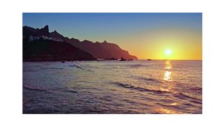 "Riding the Sunset Waves: Surfing on the Ocean's Coast"