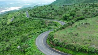 Curvy road on a tree covered hill #febspot