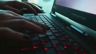 A Person Typing On A Laptop Keyboard