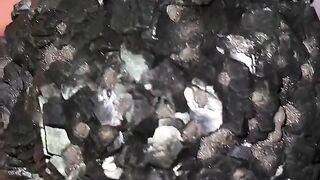 A nearly perfect, ball-shaped crystal formation,