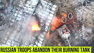 Russian troops flee from their burning tank.