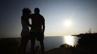 Sunset Romance, Couple hugging and kissing At Sunset, Beautiful Young Couple in Love.