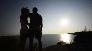 Sunset Romance, Couple hugging and kissing At Sunset, Beautiful Young Couple in Love.