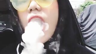 Beautiful girl making vape rings