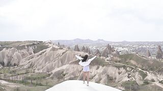 A Woman Running on the Rock Formation