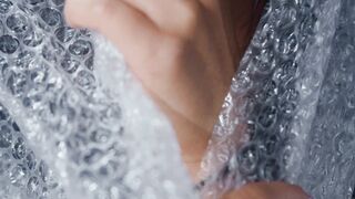 Women Popping Bubble wrap
