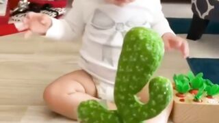 Most adorable baby playing with cactus toy