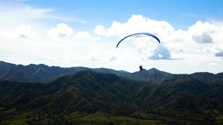 Skydiver flying over a mountain range 4k