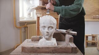 Artist using Hummer and Chisel on sculpture