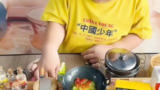 Cute baby having fun in his mini kitchen