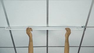 vecteezy_close-up-of-a-man-s-hand-installing-a-long-led-light-bulb
