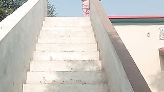 A little girl standing at top of the house
