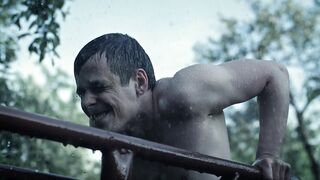 Shirtless Man Exercises In The Rain