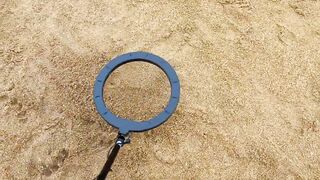finding toy cars with metal detector in beach