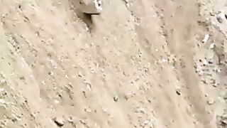 Impressive movement of an  Excavator coming down from a mountain