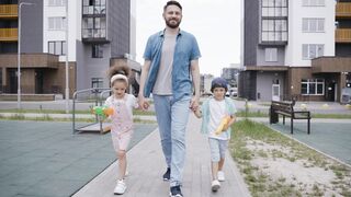Happy father walking with his kids