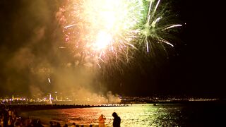 Fireworks illuminating the beach sky