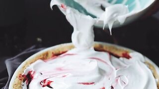 Person Spreading Meringue on a Pie
