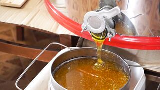 Pouring Sweet Liquid Honey On A Stainless Container