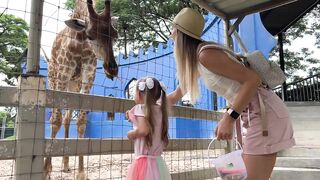 Tim y Essy alimentan la jirafas en un zoológico de Tailandia