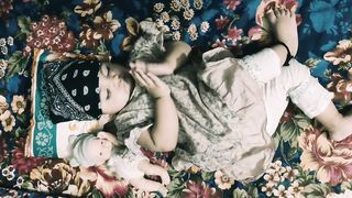 Cute baby girl playing with doll