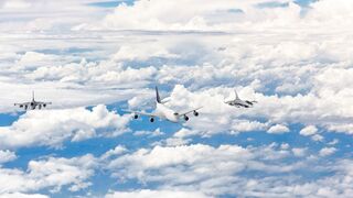 Jetfighter Escorting a Commercial Airplane
