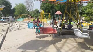 Village Kids Enjoying Swings at Park