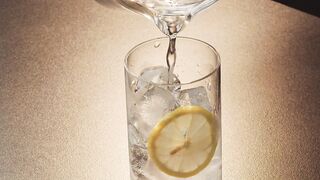 Lime glass with lemon and ice