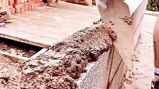 Sharing small skill of bricklaying on the exterio wall of the construction site.