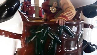 Abdullah is sitting on electric panda ride.