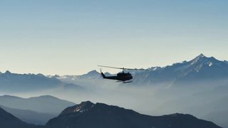 Helicopter flying over the mountains