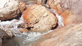view of water falling  from inside Mountain