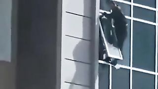 The man climbed out of his eighth floor apartment window to catch the helpless three years old