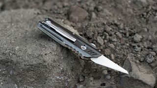 Titanium Dual-Action Automatic Utility Knife & Comb has a replaceable blade design