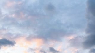 White clouds play in the blue sky