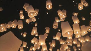 Beautiful fire balloon in the night sky at a holiday.