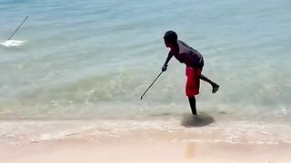 Australian Aboriginal spear fishing from the shore.