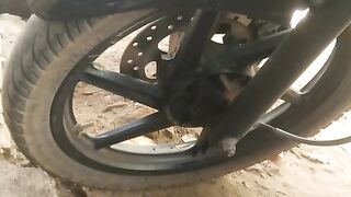PULSAR Motor Bike in a garden parking lot.