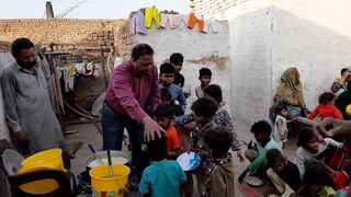 Serving food to brick kiln worker children.