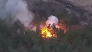 Ukrainian soldiers blow up camouflaged Russian ammo depot in forest