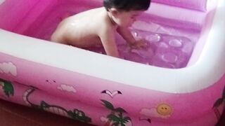 sweet little girl is taking a bath