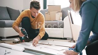 A young couple decorating house